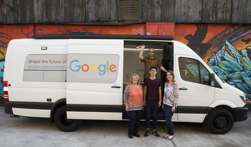 In this Wednesday, March 9, 2016 photo, Google User Experience Researcher John Webb, background, Dawn Herman, left, Henry Liang, center, and Victoria Sosik pose for a photo with Google's User Experience van in New York. (AP Photo/Mary Altaffer)