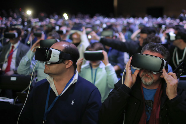 Attendees use the new Samsung Gear 360, a 360-degree camera, during the Samsung Galaxy Unpacked 2016 event on the eve of this week’s Mobile World Congress wireless show, in Barcelona, Spain, Sunday, Feb. 21, 2016. (AP Photo/Manu Fernadez)