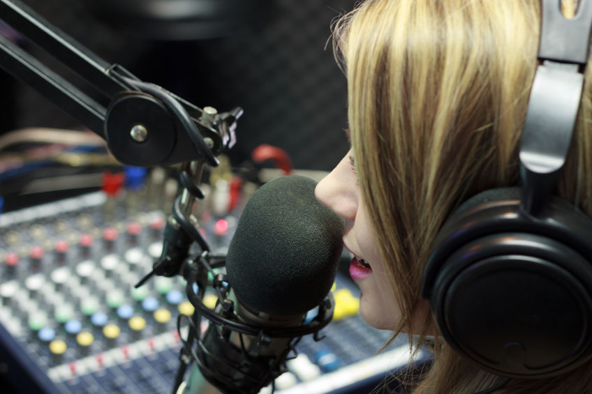32287744 - beautiful woman working as radio dj live in studio